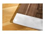 Wooden cutting board with a white marble base on a wooden surface.
