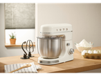 A cream-colored SILVERCREST® stand mixer with a stainless steel bowl on a wooden counter, with baking ingredients nearby.