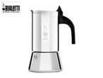 A shiny silver stovetop espresso maker with a black handle, featuring a small logo.