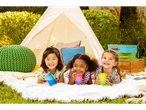 Three smiling girls with Munchkin Miracle 360° cups at a backyard picnic.