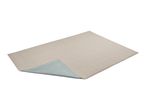 A light beige rectangular rug with a corner folded back to reveal a light blue underside.