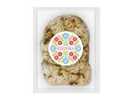 Braided cheese with herbs in clear packaging, featuring a colorful folk-art label.