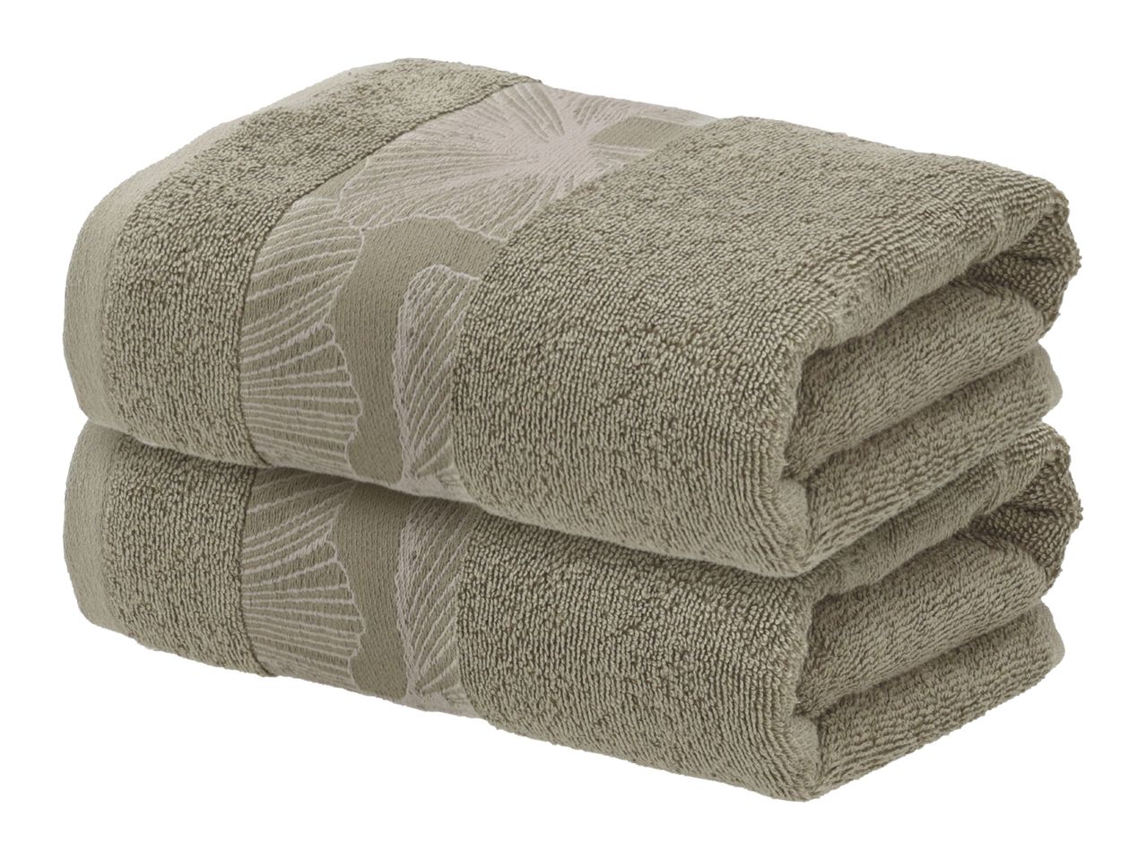 Two folded beige towels with a subtle leaf pattern.