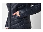 Close-up of a person wearing a dark blue quilted puffer jacket with a hand in the pocket.