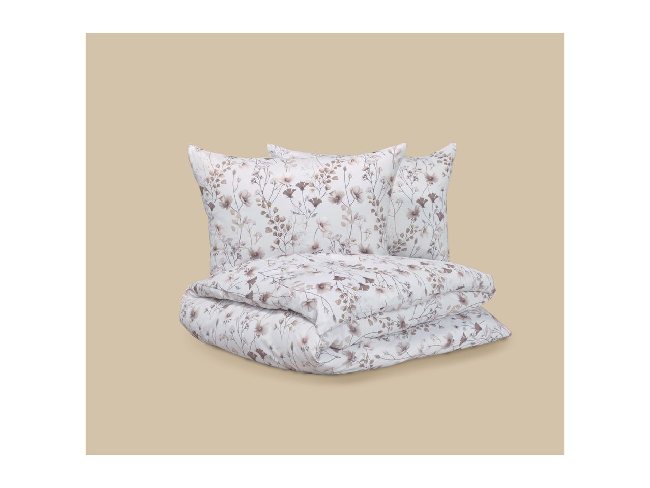 Floral patterned bedding set with two pillows and a folded duvet