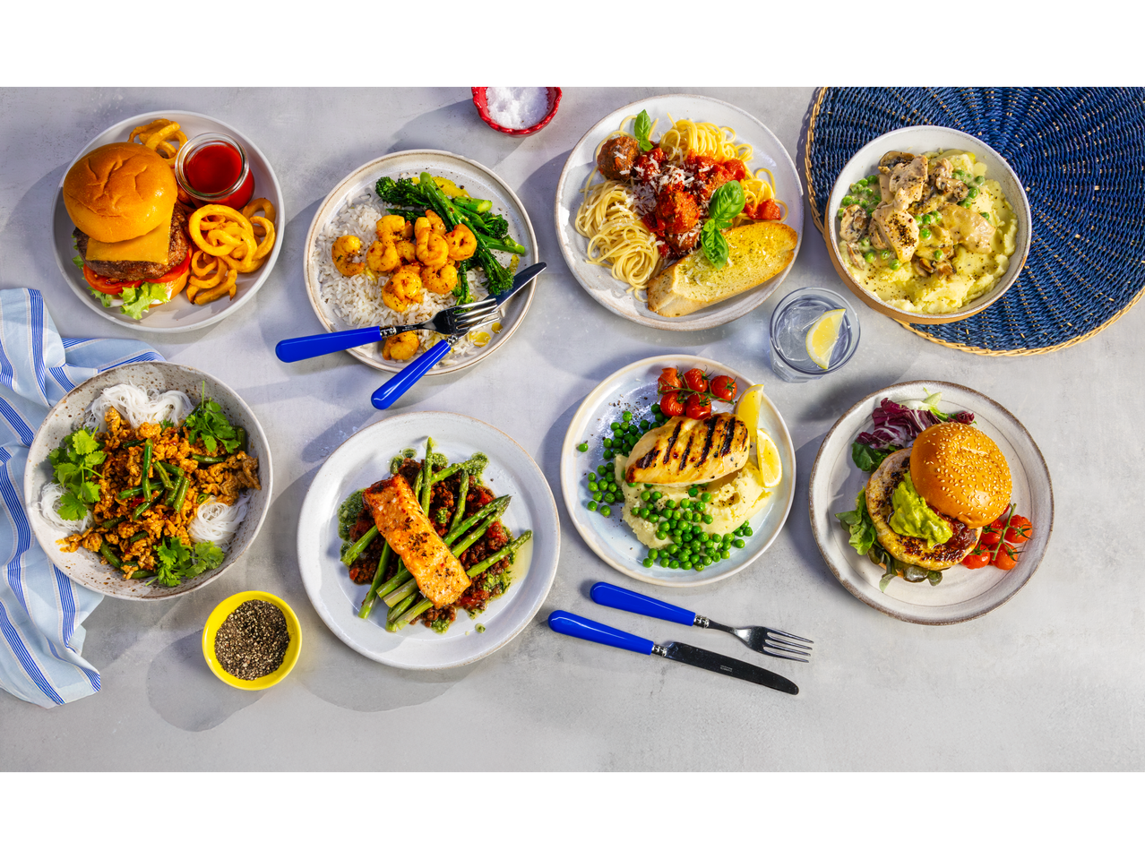 A variety of meals including burgers, pasta, salmon, chicken, and shrimp dishes.