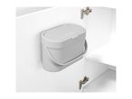 Grey waste bin mounted on the inside of a white cabinet door