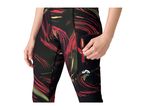 Woman in black, red, and green patterned sports leggings with a zippered pocket.