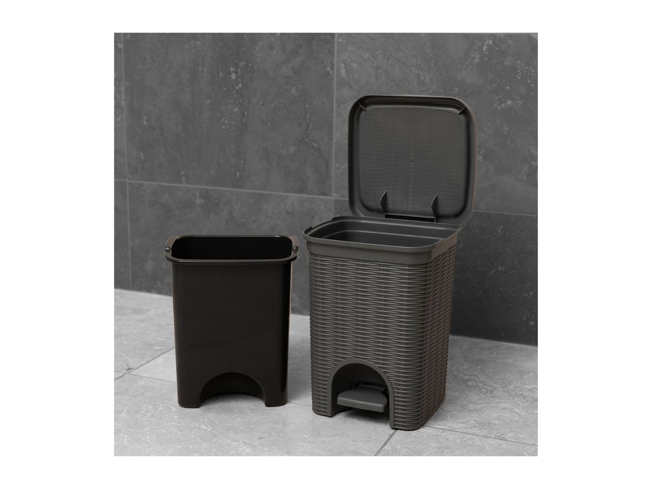 Two dark-grey plastic step trash cans, one with a lid open, the other closed.