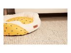 Cath Kidston bee-patterned pet bed on a textured rug.