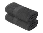 Two dark grey, folded bath towels stacked on top of each other.