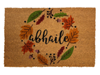 Doormat with a fall-themed wreath design and the word 'abhaile' in the center.