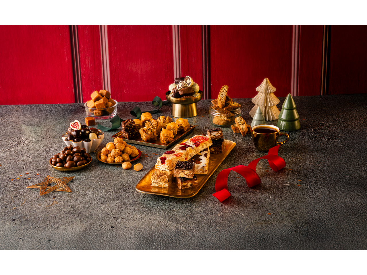 Christmas sweets assortment: nougat, baklava, caramels, chocolates, biscotti, and coffee.