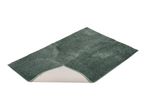 Green bath mat with a non-slip backing partially visible