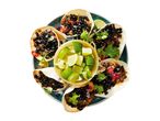 A plate of delicious-looking tacos with black beans and a side of pico de gallo.