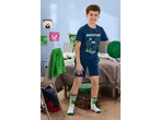 Boy in a blue Minecraft T-shirt and shorts, holding a green basketball in a Minecraft-themed room.