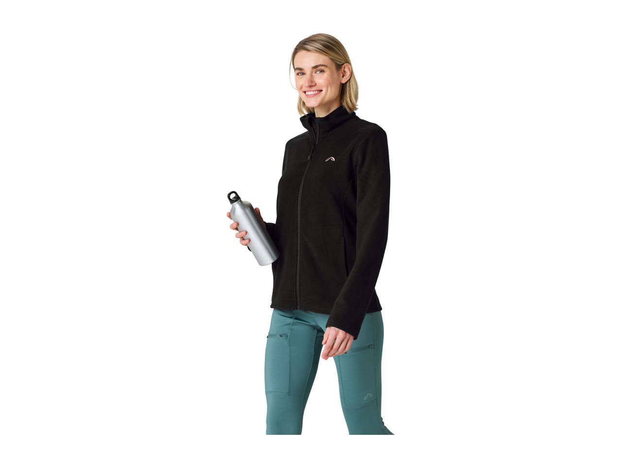 A woman wearing a black fleece jacket and teal leggings, holding a silver water bottle.