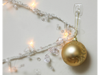 Golden Christmas ornament hanging from a 3M Deko-Clips/Haken hook, with lights.