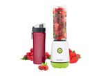 Personal blender with a bottle full of berries and a separate red water bottle.