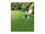 Green garden pest repeller with 360-degree coverage in a lush garden setting.