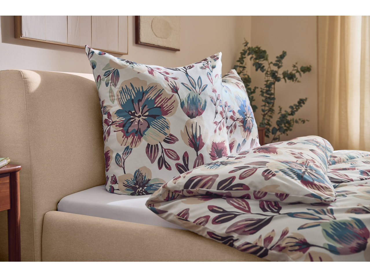 Floral duvet cover set with pillows on a bed in a cozy bedroom.