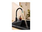 Black kitchen faucet with water flowing into a black sink
