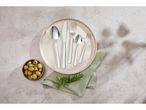 A set of elegant stainless steel cutlery rests in a plate.