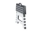 A folded, polka-dotted plastic step stool.