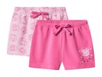 Two pairs of pink shorts for girls, one with an all-over pig print and the other with a single pig graphic.