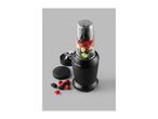 Black personal blender with a clear cup filled with mixed berries and grapes, with loose berries nearby.