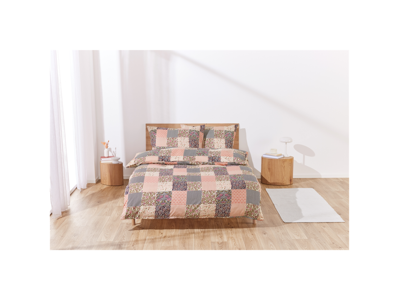 Patchwork-style bedding set on a bed in a bright bedroom.