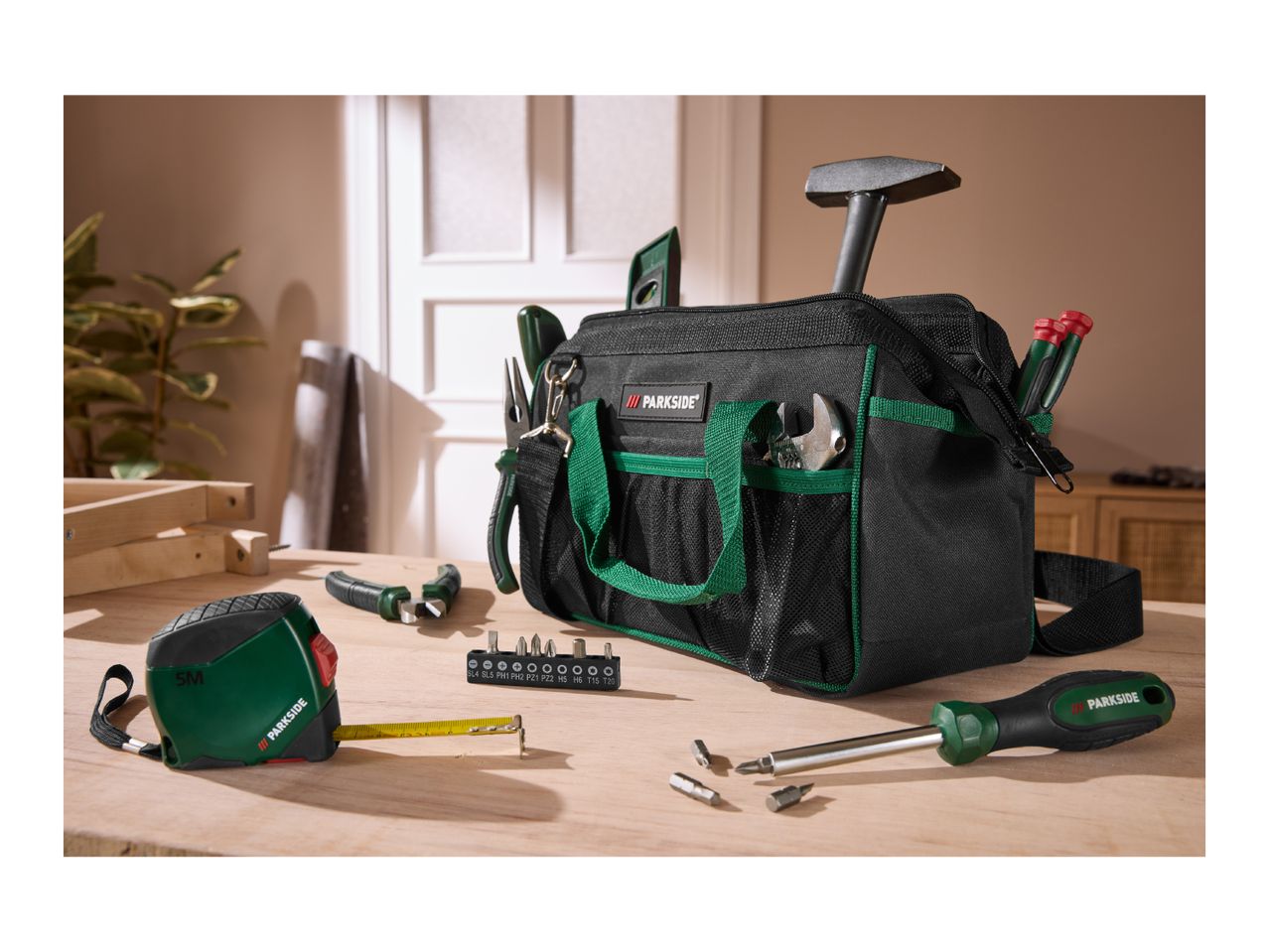 Tool bag with various hand tools, including a tape measure, screwdriver, and pliers.
