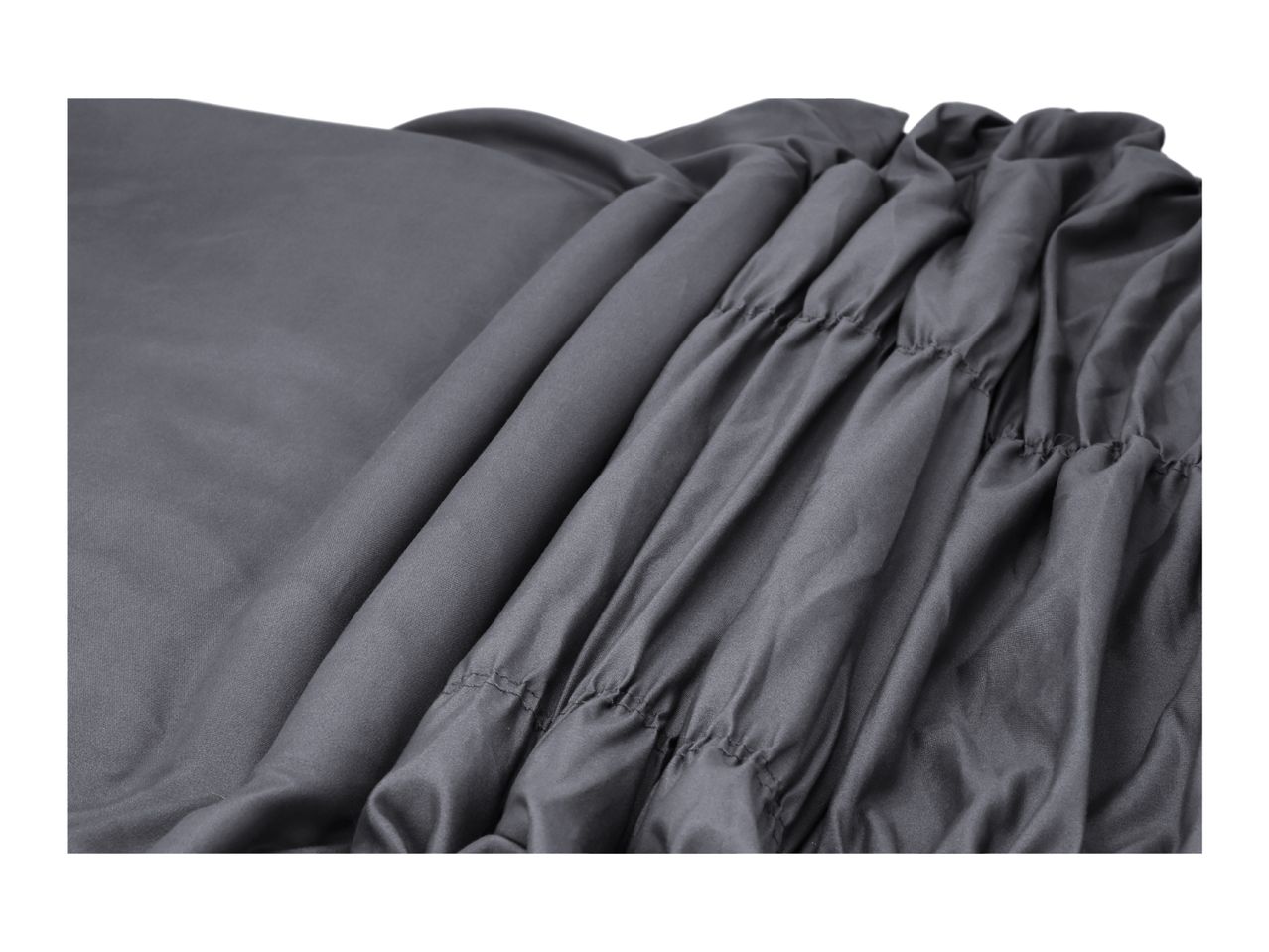 Close-up of a dark grey fitted sheet with elasticated ruching.