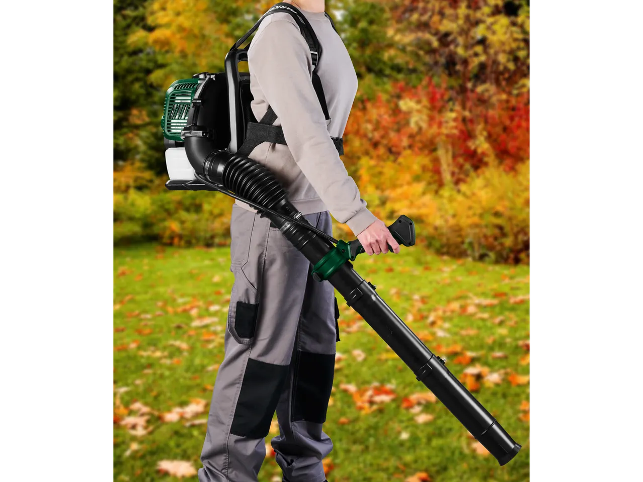 Person wearing a backpack leaf blower and holding the nozzle