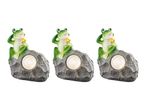 Three garden lights featuring frog figurines on rock bases.