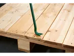 A green crowbar is used to pry apart two wooden planks on a pallet.