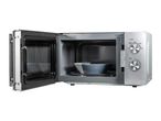 Silver microwave oven with door open, showing a bowl inside and power/time dials.