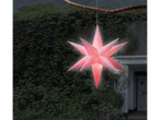 LIVARNO home Inflatable LED Christmas Star hanging from a branch in front of a house.
