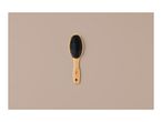 A wooden hairbrush with black bristles on a light brown background.