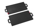 Two cast iron griddle plates, one smooth and one ribbed, for cooking.