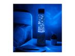 Blue lava lamp with game characters, notebook, and succulent on a bedside table.