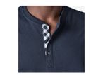 Close-up of a man wearing a dark blue Henley shirt with a checkered placket.