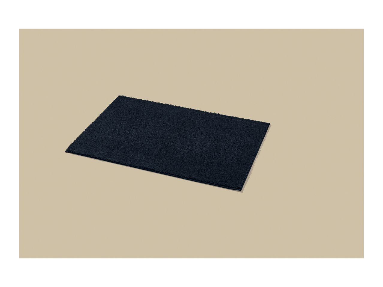 Dark blue rectangular bath mat on a light beige background.