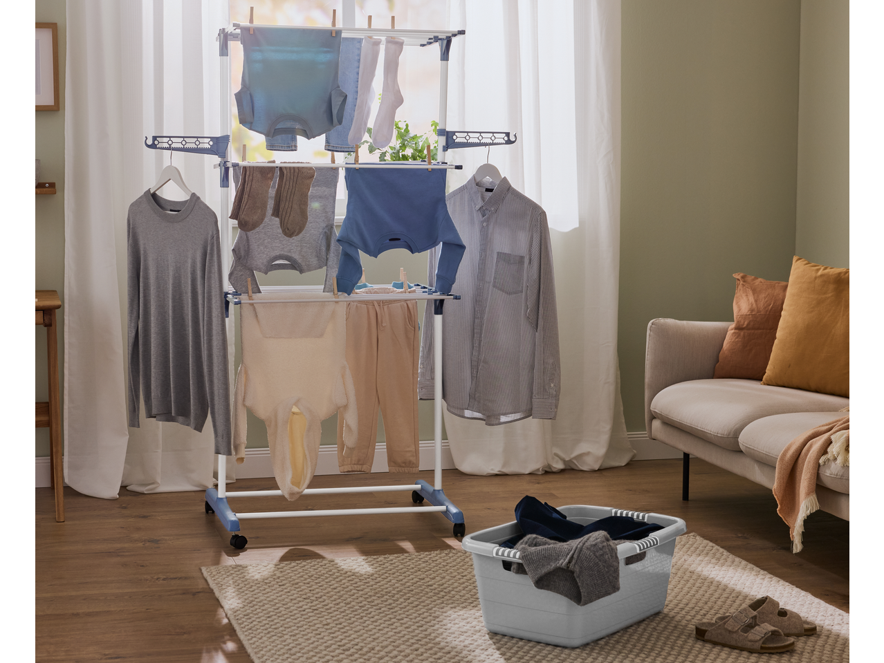W5 3 Tier Clothes Airer with various clothes drying in a bright room.