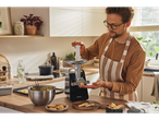 A man uses a SILVERCREST® Electric Mincer to make cookies in a kitchen.