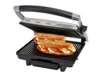 Open contact grill with two grilled vegetable and mozzarella sandwiches.