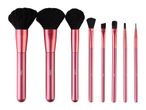 Rose gold makeup brush set with three large powder brushes and several smaller detail brushes.