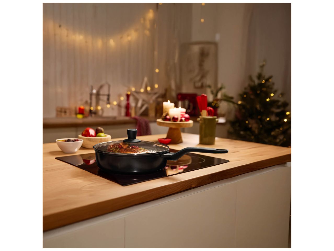 Poêle à frire sur une plaque de cuisson dans une cuisine décorée pour Noël