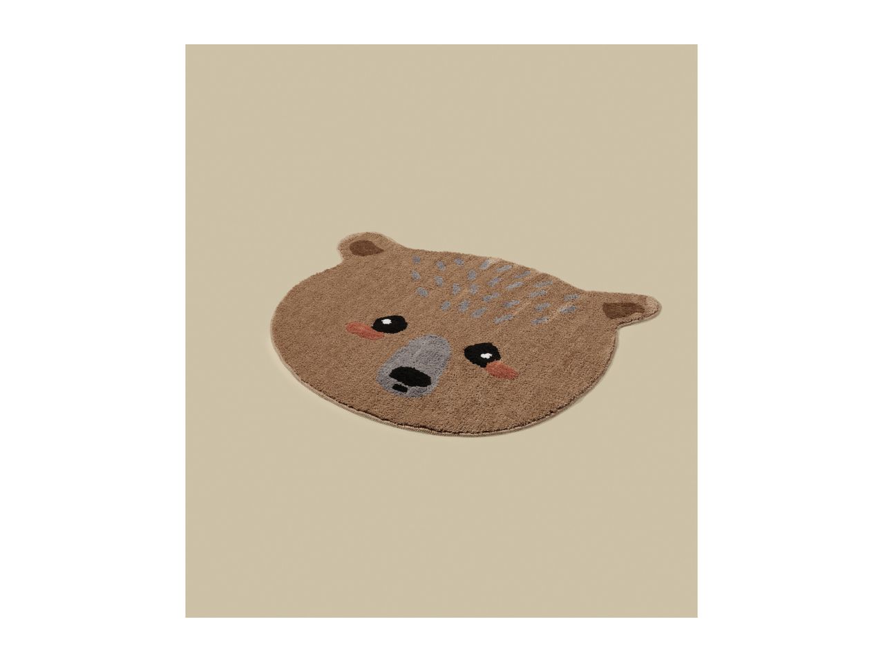 Brown bear-shaped bath mat with a cute face on a beige background.