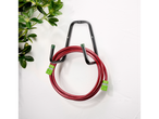 Red garden hose and wall-mounted hose holder.